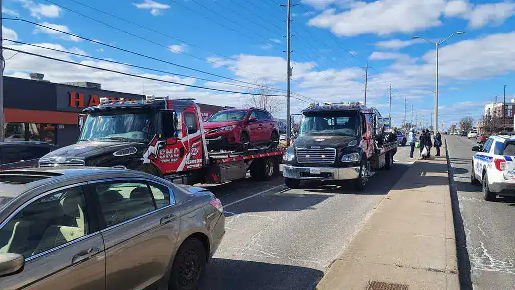 Overheating vehicle in Ottawa traffic receiving emergency roadside help from SMC Towing Group to prevent engine damage - SMC Towing Group Overheating vehicle in Ottawa traffic receiving emergency roadside help from SMC Towing Group to prevent engine damage