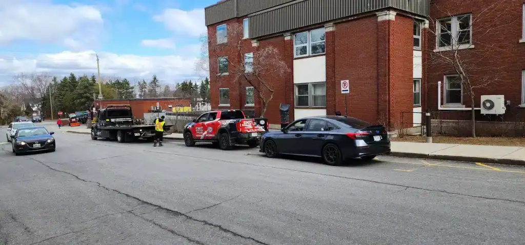 SMC Towing Group assisting with a car stuck on train tracks in Ottawa using professional emergency towing equipment