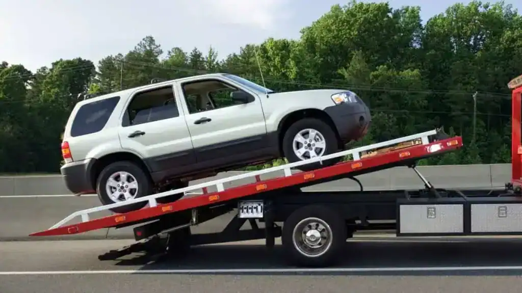 SMC Towing Group inspecting an overheating car in Ottawa traffic with the hood open during roadside assistance